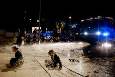 Police use a water cannon to disperse demonstrators during a protest against the recruitment of Ultra orthodox Jews to the IDF, in Jerusalem, June 30, 2024.