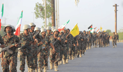 Houthi soldiers holding Iranian and Hezbollah flags