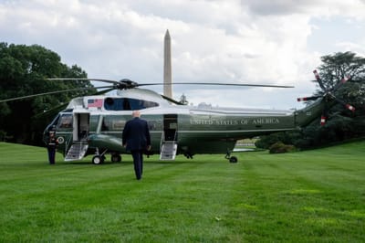 President Donald Trump beside Marine One Helicopter