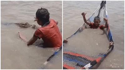 Only in Africa: Child Calmly Confronts Crocodile While Relaxing in River Hammock | WATCH