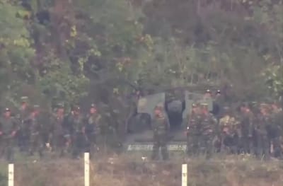 North Korean Soldiers Display Anti-US Signs at Fortified Border