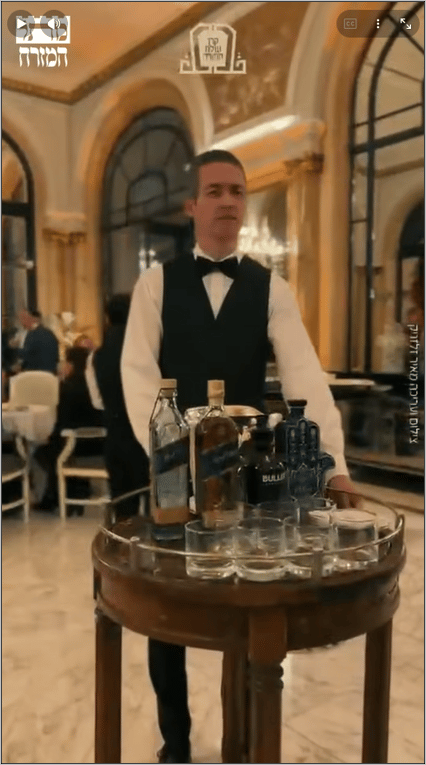 Waiter with whisky trolley at a fundraising evening for Olam HaTorah