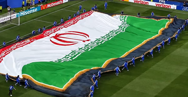 Iranian team unfurls the flag before the match