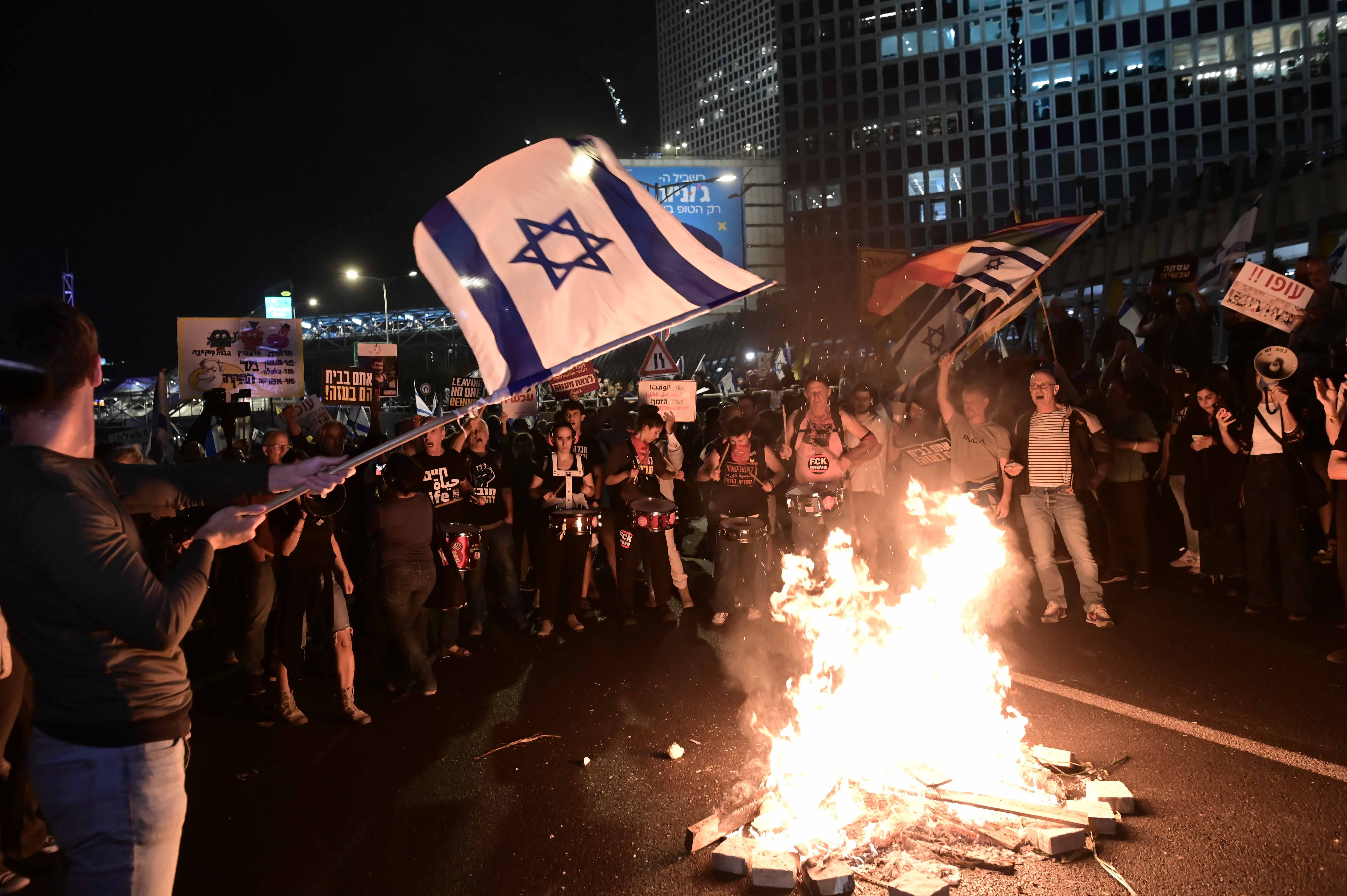 Fires break out as Israelis protest the firing of Defense Minister Gallant