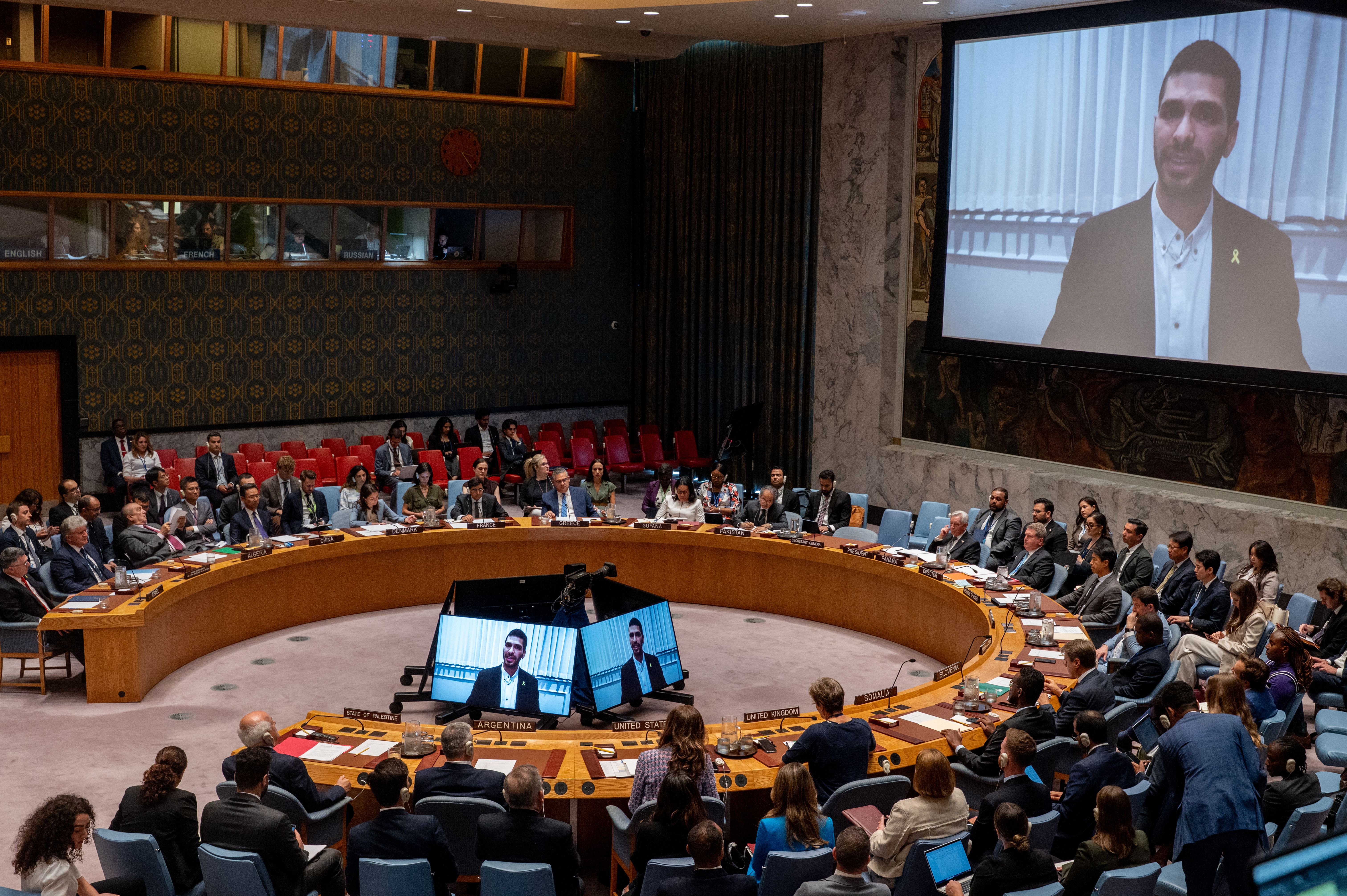 Ilay David, brother of hostage Evyatar David speaks on a screen during a meeting at the United Nations headquarters in New York City on the medical condition of hostages held in the Gaza Strip, August 5, 2025.
