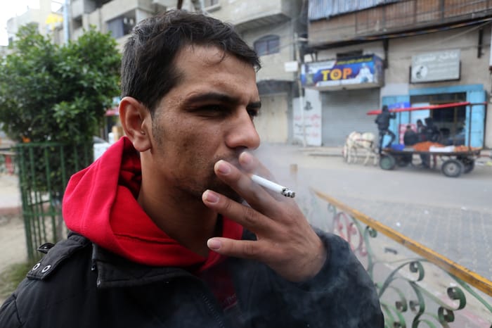 A Palestinian man selling cigarettes in his shop, at Rafah in southern Gaza Strip.                          