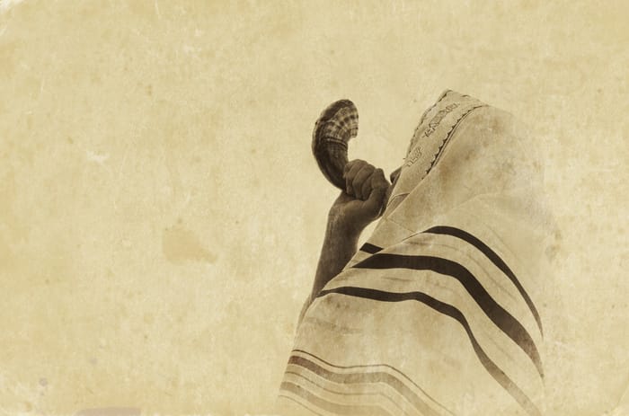 Jewish man blowing the Shofar (horn) 