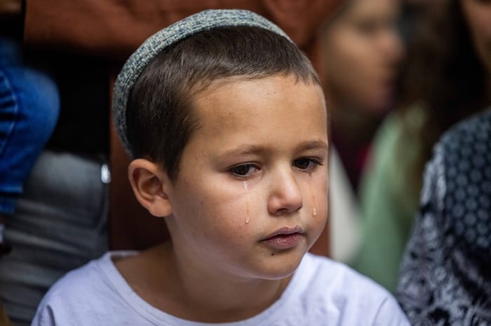 Family and friends mourn over the grave of Sayeret Matkal soldier David Meir, killed on October 7 during a memorial ceremony marking one year to his death at Mount Herzl Military Cemetery