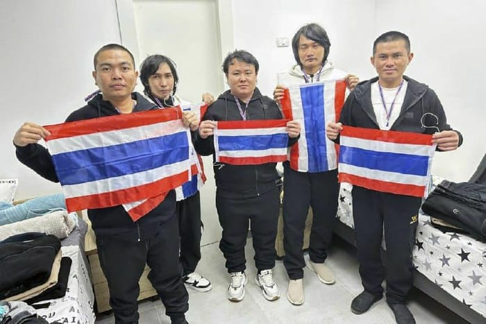 Thai hostages who were freed from Hamas captivity, from left to right, Surasak Lumnau, Sathian Suwannakham, Bannawat Saethao, Watchara Sriaoun and Pongsak Thaenna, hold the Thailand flag