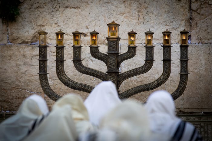 Ultra Orthodox Jews pray in front of the Menorah at the Western Wall 