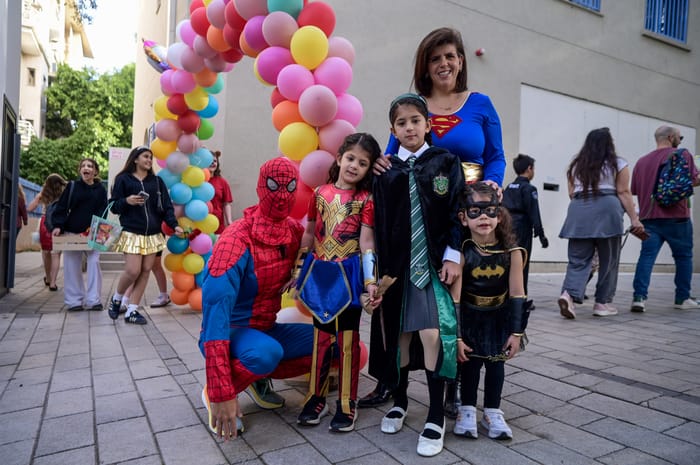 hool kids, their teachers and parents dressed up in costumes seen at the Gabrieli Carmel School in Tel Aviv, ahead of the the Jewish holiday of Purim, March 13, 2025. 