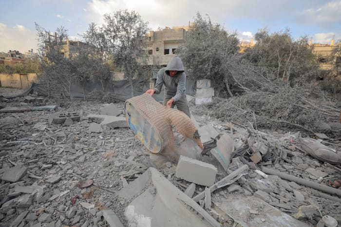 Palestinians at the scene of an Israeli airstrike in Gaza City, on March 18, 2025