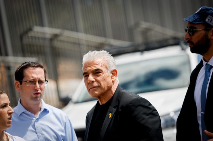Head of opposition Yair Lapid attends a protest against the decision of Israeli prime minister Benjamin Netanyahu to fire head of Shin Bat Ronen Bar, outside the PM's office in JerusalemJerusalem, March 19, 2025.