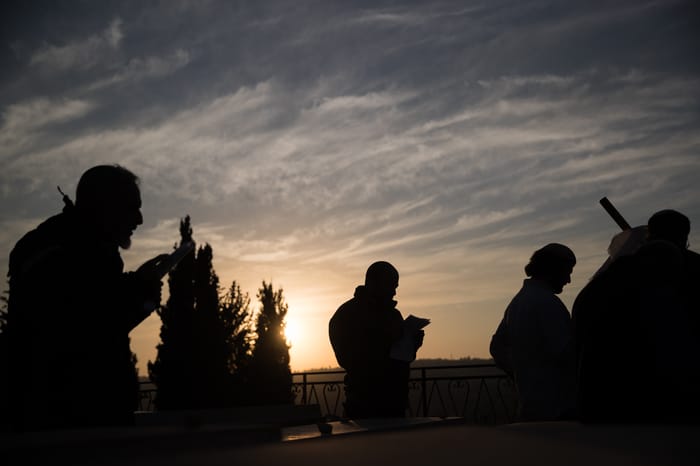 Followers of the late Rabbi Meir Kahane, founder of both the Jewish Defense League (JDL) and "Kach" an Israeli political party, pray at his grave at the Givat Shaul cemetery