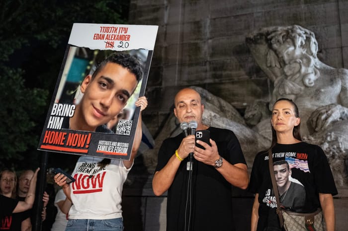 Adi Alexander speaks with Yael at his side, parents of Edan Alexander