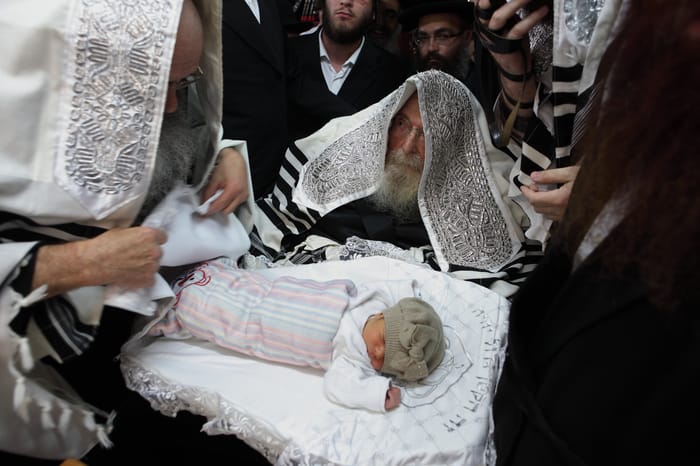 Illustration: The rebbe of Sadigora takes part at a circumcision ceremony in the city of Bnei Brak