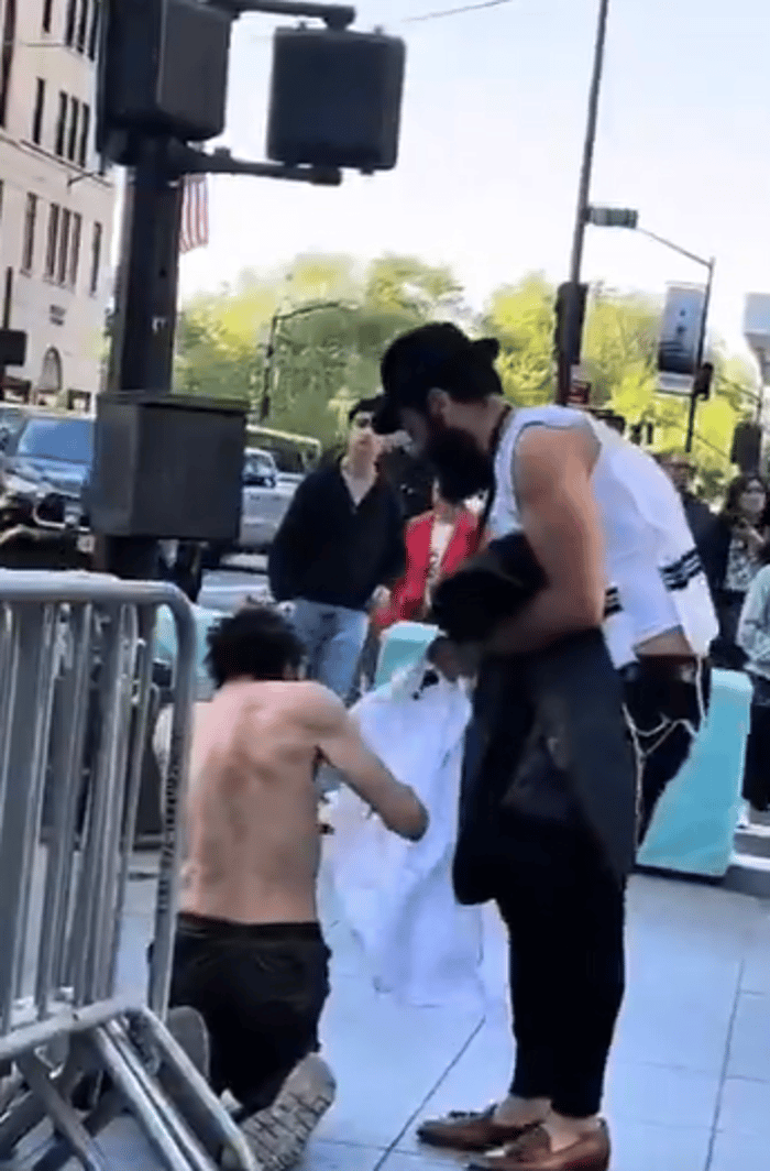 Chabad hassid giving the shirt off his back to a homeless man