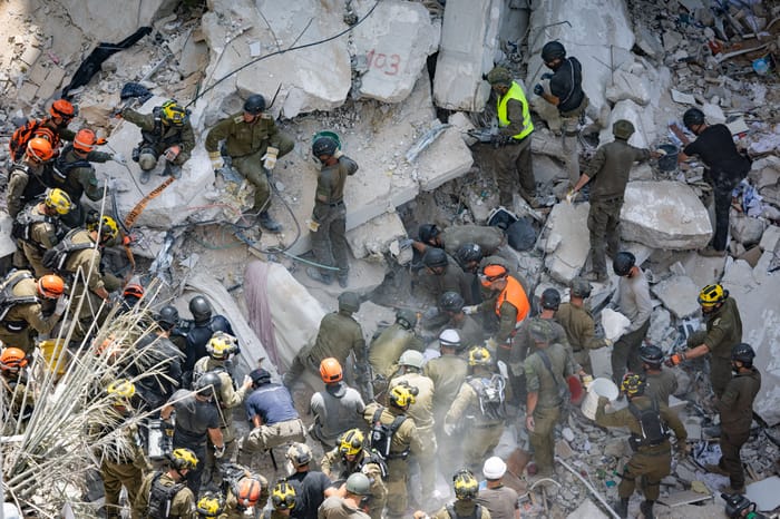 Home Front Command forces at the scene where a ballistic missile fired from Iran hit and caused damage in Bat Yam, central Israel. June 15, 2025.