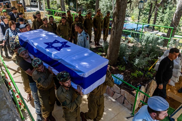 Family and friends of Israeli soldier Staff sergeant Moshe Shmuel Noll attend his funeral at the Mount Herzl Military Cemetery in Jerusalem on July 9, 2025. He was killed in combat in the Gaza Strip.