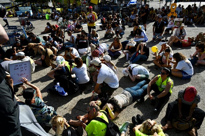Civilians crouching for cover amid air raid siren