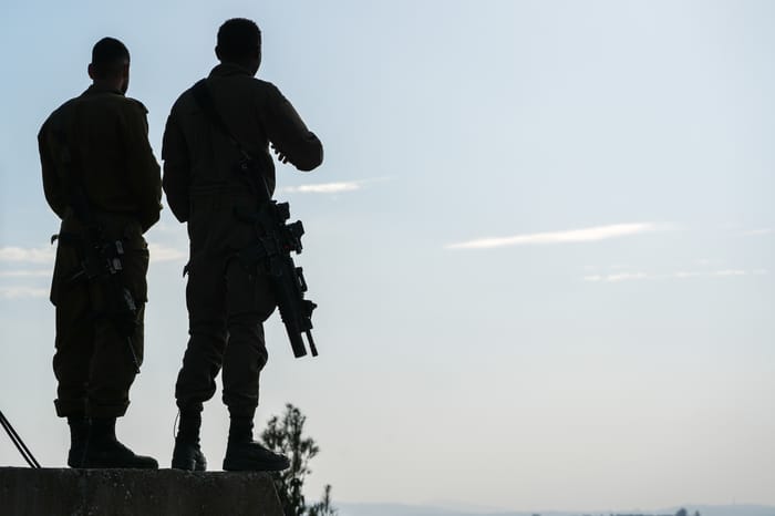 Israeli soldiers stand near the border with Lebanon in northern Israel, December 4, 2025.