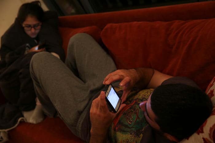Israeli teenagers play Candy Crush their smartphones in their house room, in Tzur Hadassah on November 15, 2013. 