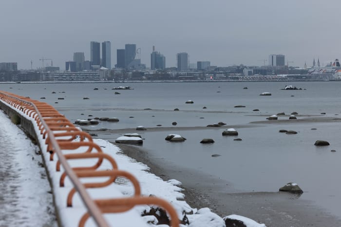 Walking along the water in Tallinn, Estonia, covered in snow. November 25, 2022.