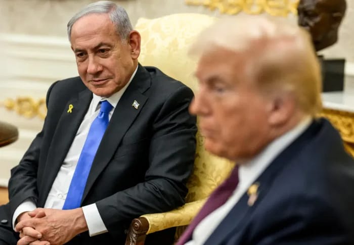 Bnejamin Netanyahu sits next to President Trump