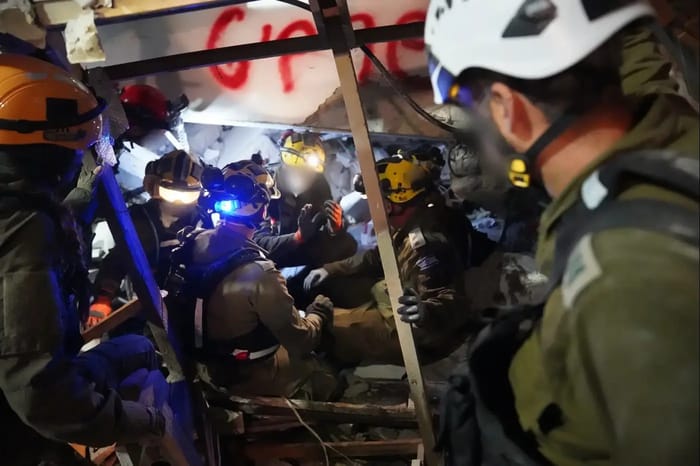 Searching for people trapped after Iranian missile hits Haifa building