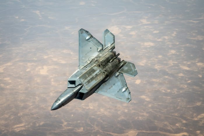 A U.S. Air Force F-22 Raptor stealth fighter is refueled by a KC-135 Statotanker while flying over the Middle East.