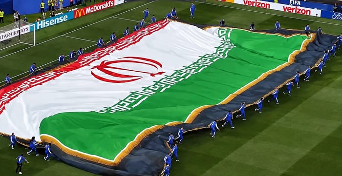 Iranian team unfurls the flag before the match