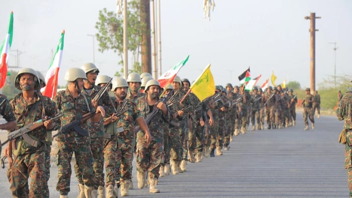 Houthis holding Iranian and Hezbollah flags
