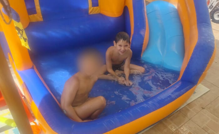 The two boys playing in the pool before the attack where Hillel was killed