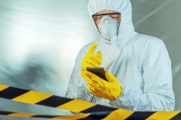 Epidemiologist using smartphone in hospital virus infection quarantine