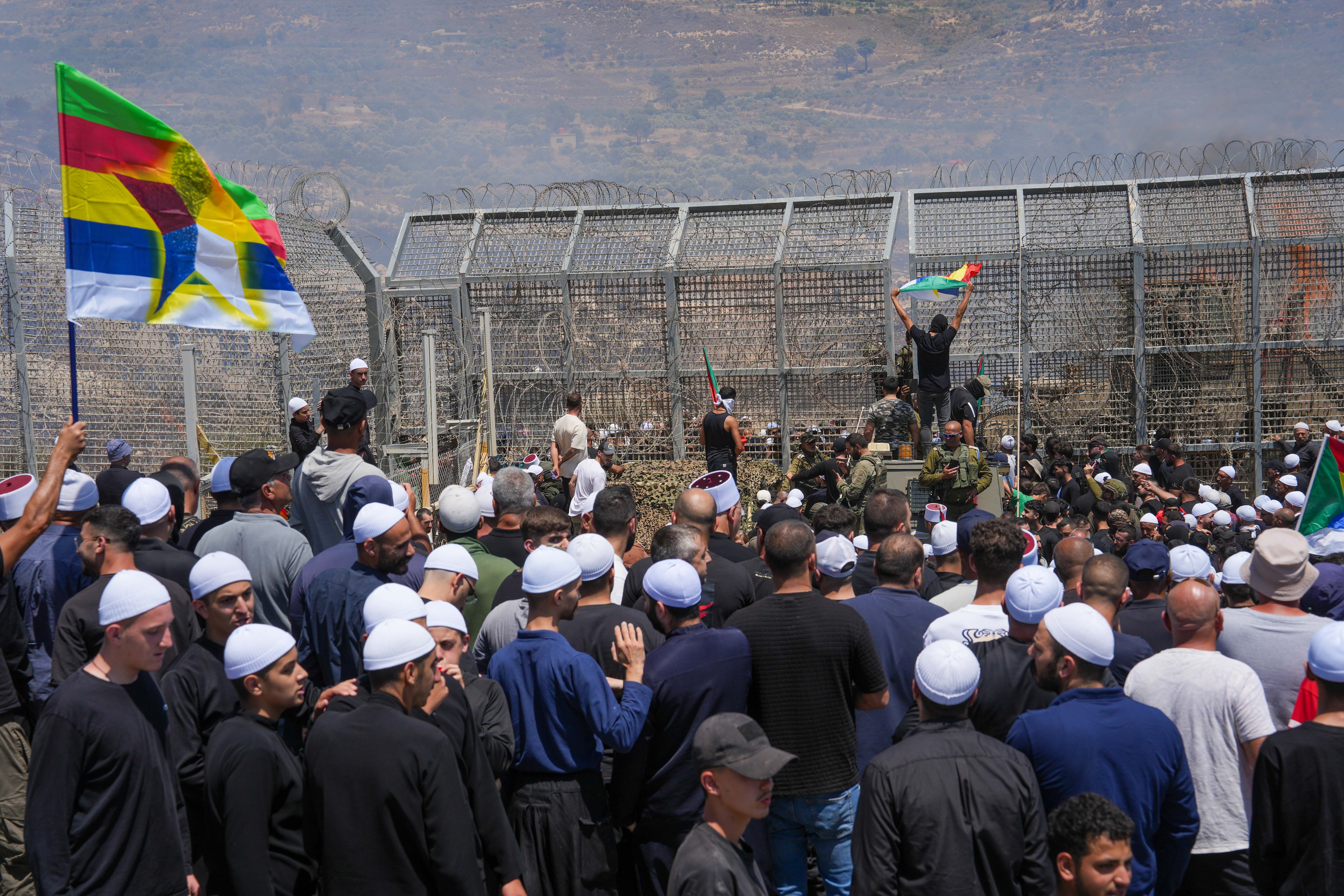 ruze residents protest near the Israeli-Syrian border fence in solidarity with their community in Syria, in Majdal Shams, July 16, 2025.