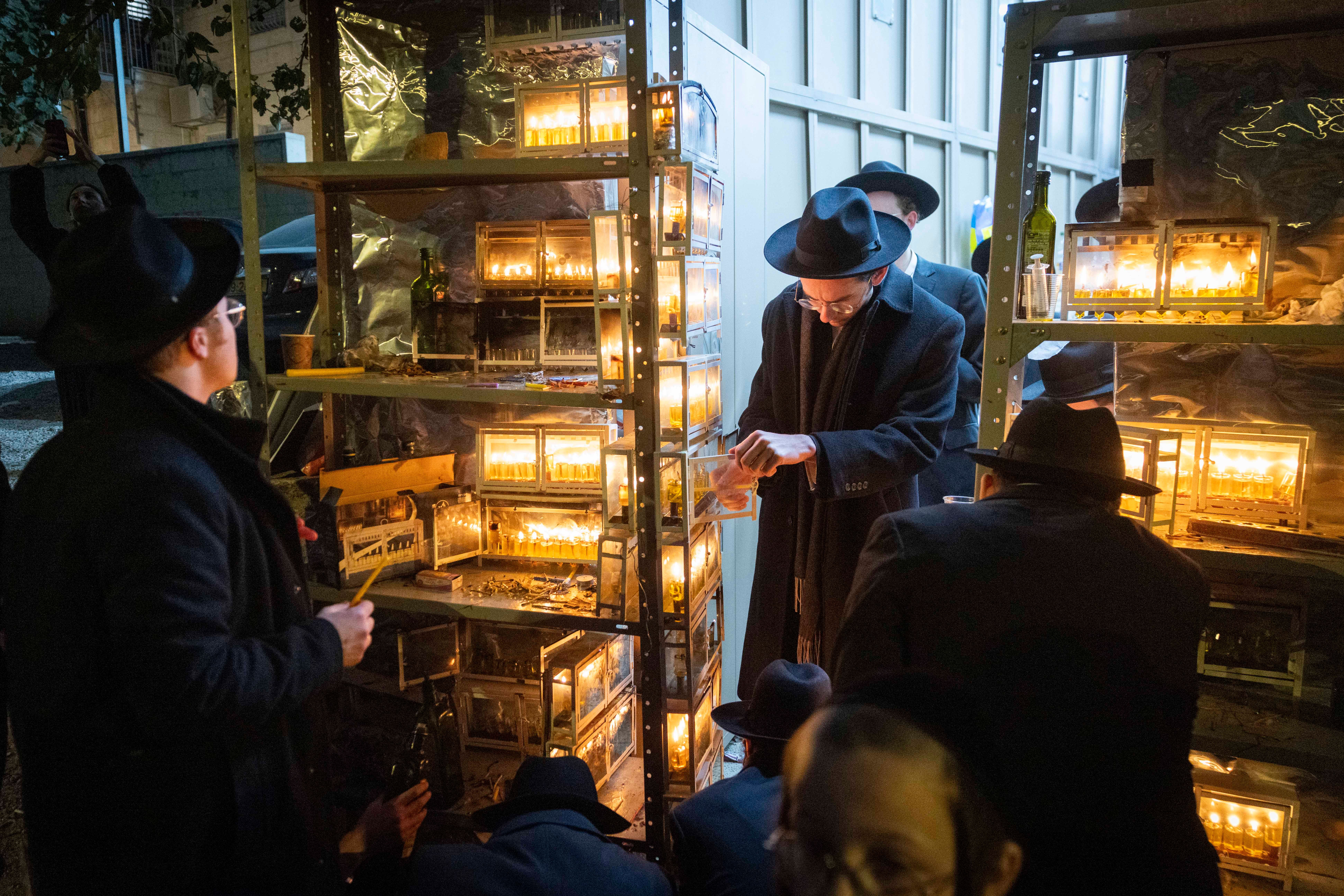 Lighting chanukah candles in Meah Shearim
