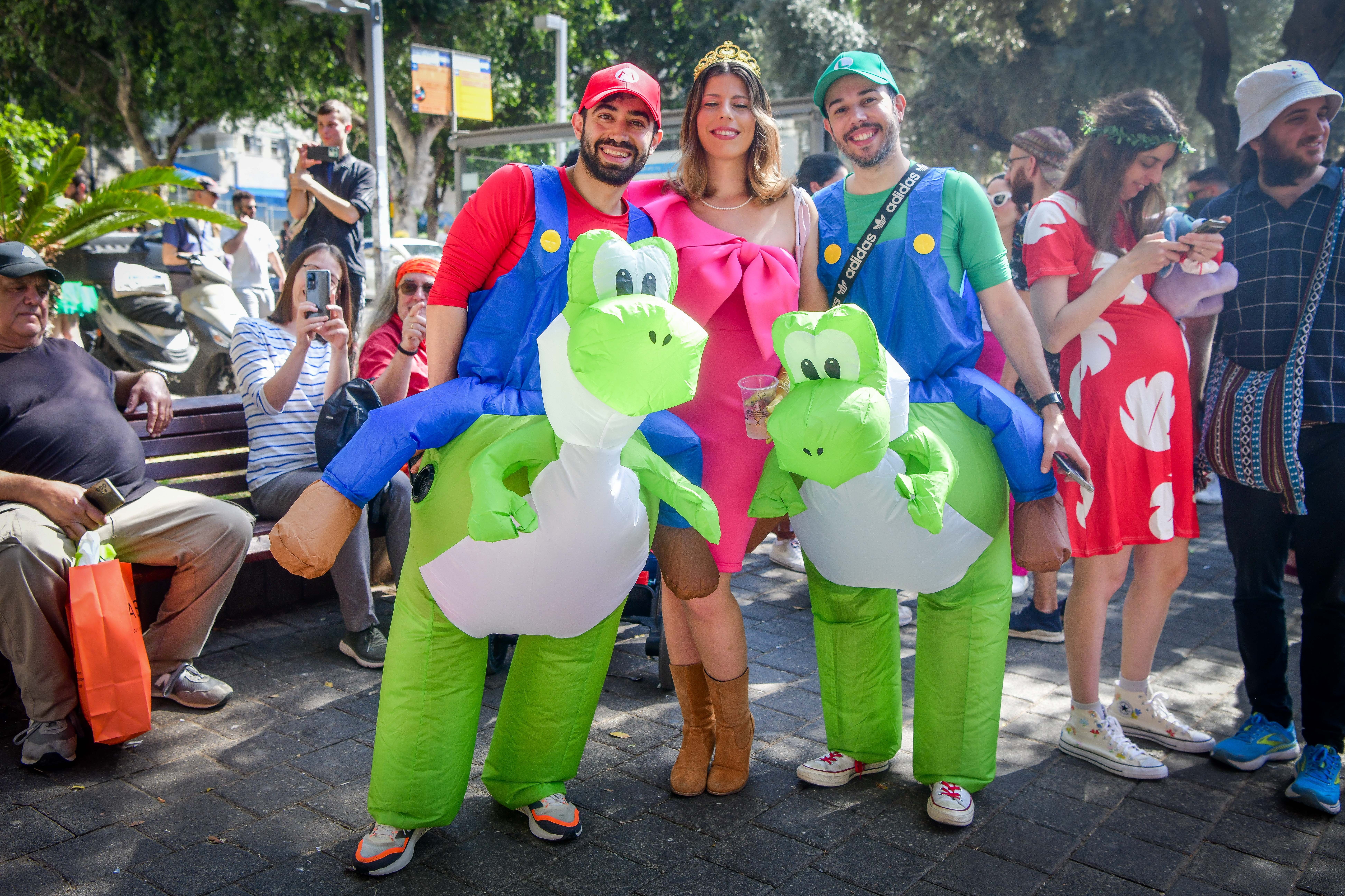 People wearing costumes celebrate the jewish holiday of Purim in Tel Aviv, March 14, 2025.