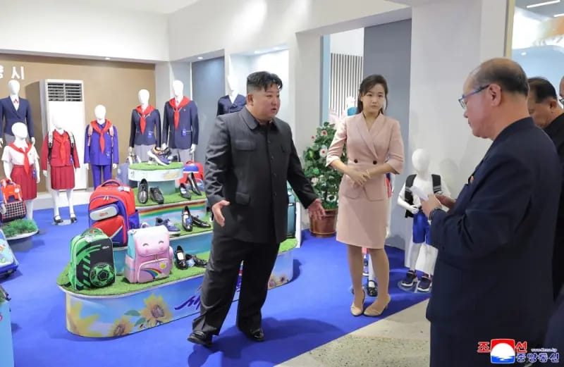 In a photo released by the North Korean government on Monday, North Korean leader Kim Jong Un is seen accompanied by his daughter Ju-ae at a clothing and footwear exhibition site.