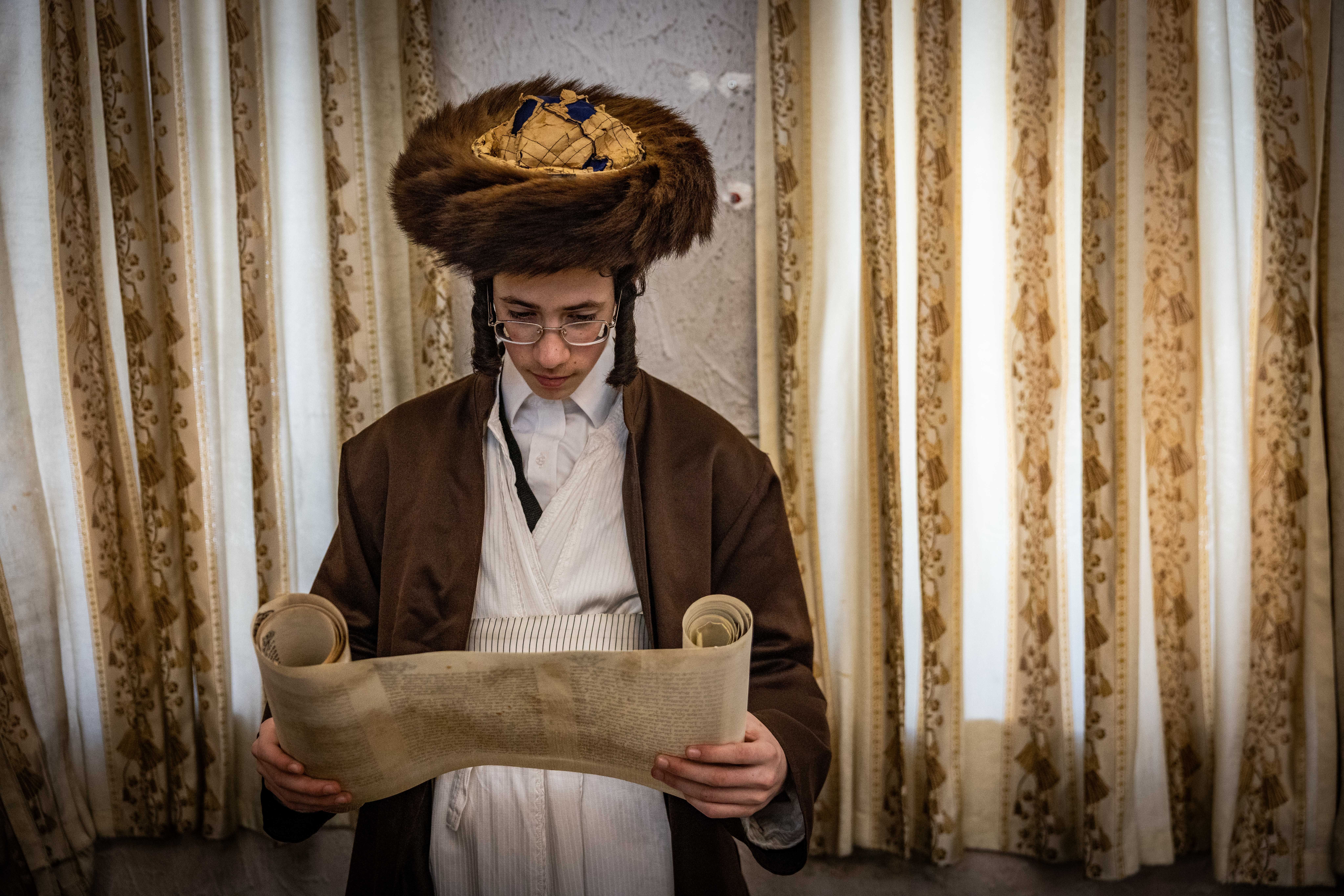 Ultra Orthodox Jews read the Scroll of Esther, which tells the story of the Jewish festival of Purim, during the Jewish holiday of Purim, in the ultra orthodox neighborhood of Mea Shearim, in Jerusalem, March 14, 2025.
