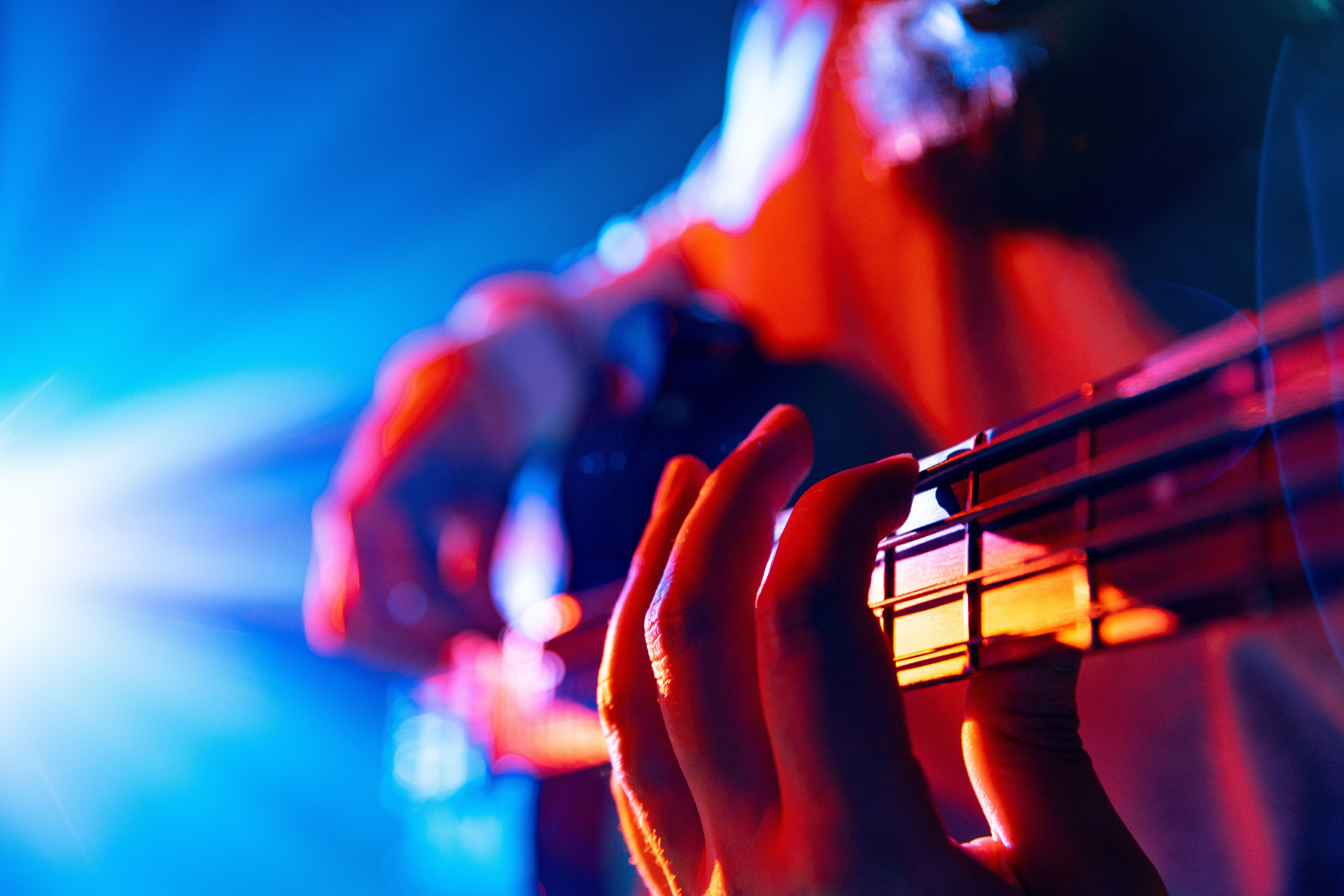 Bassist's hands playing melodic chords of new track