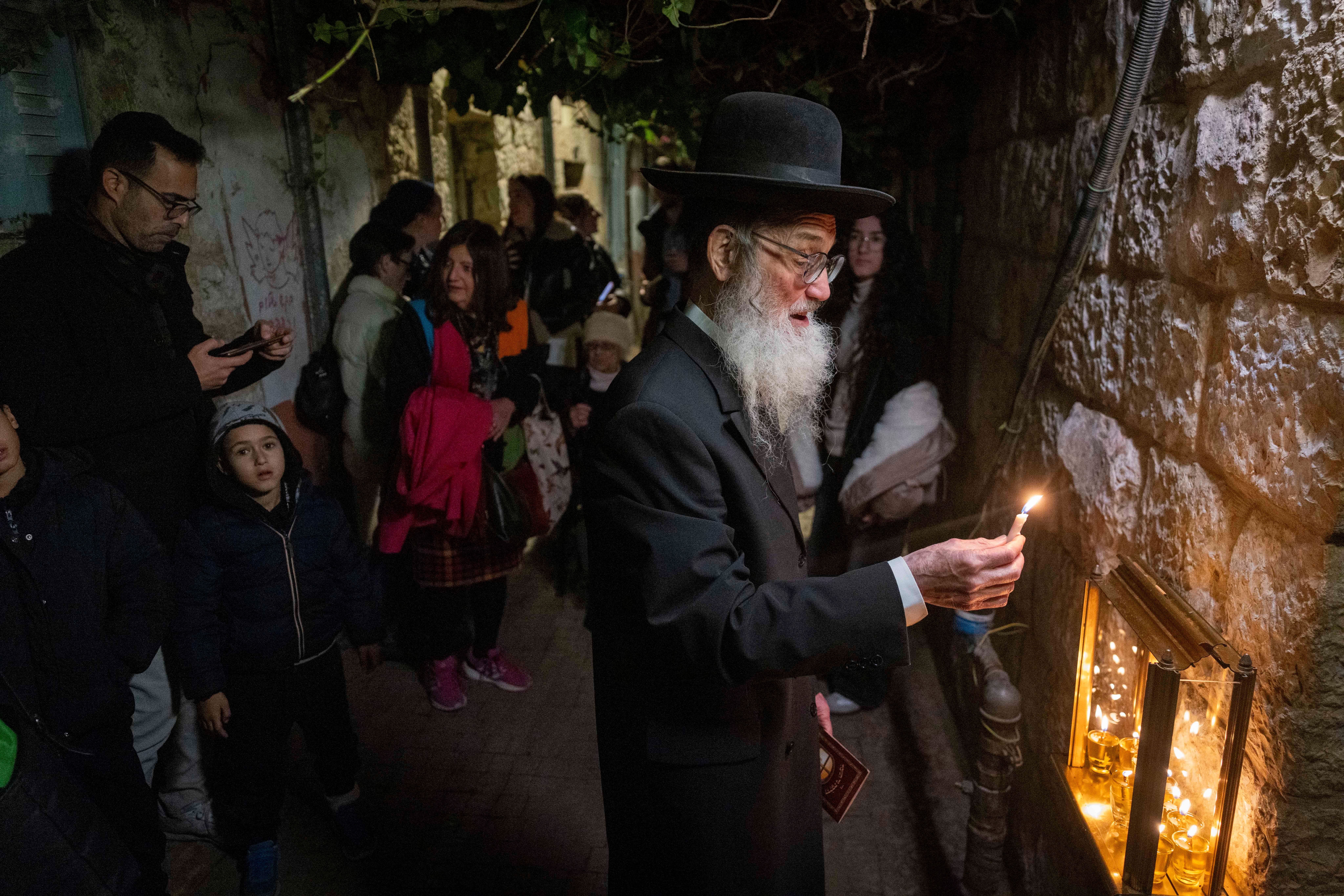Haredi man light Hanukkah candles, Nachalot, December 2025