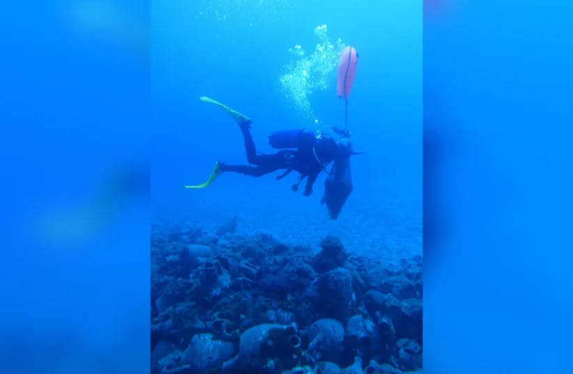 A diver beside the discovered jars.