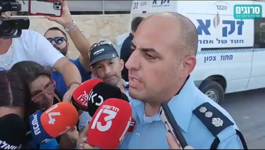 Police spokesman Eli Levi at the scene of the massacre in Basmat Tab'un