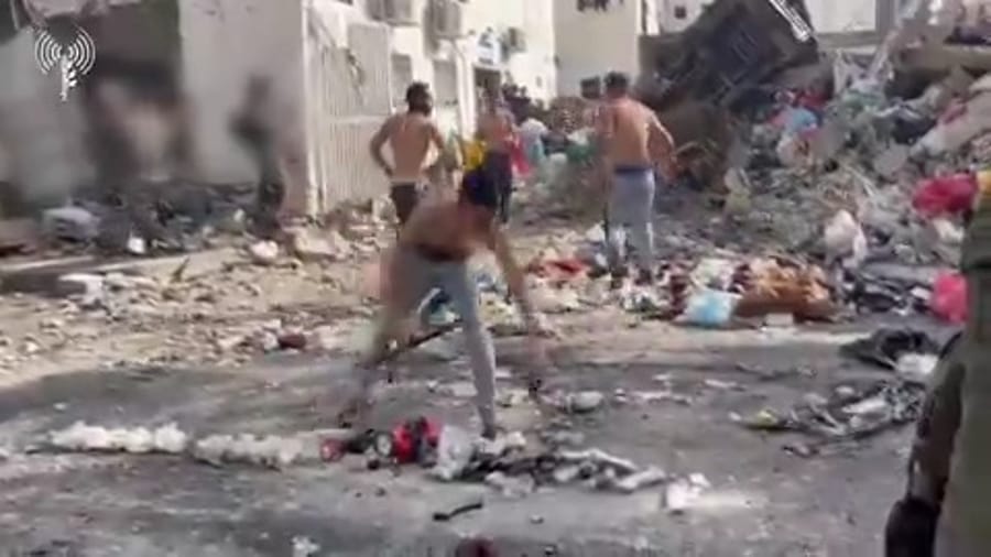 Hamas terrorists surrendering their weapons and clothes.