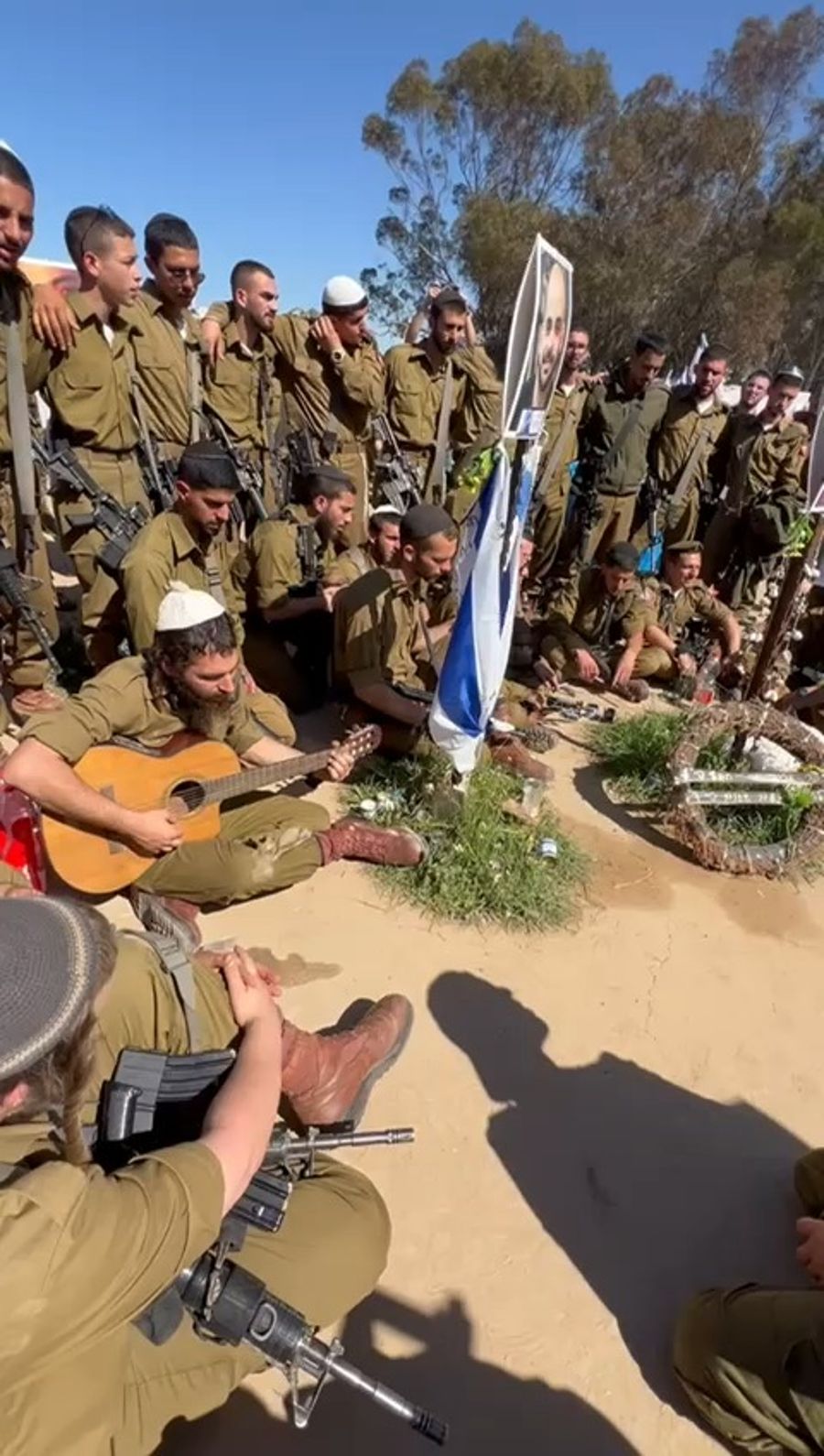 Singing in memory of the fallen at the Nova Party Massacre.