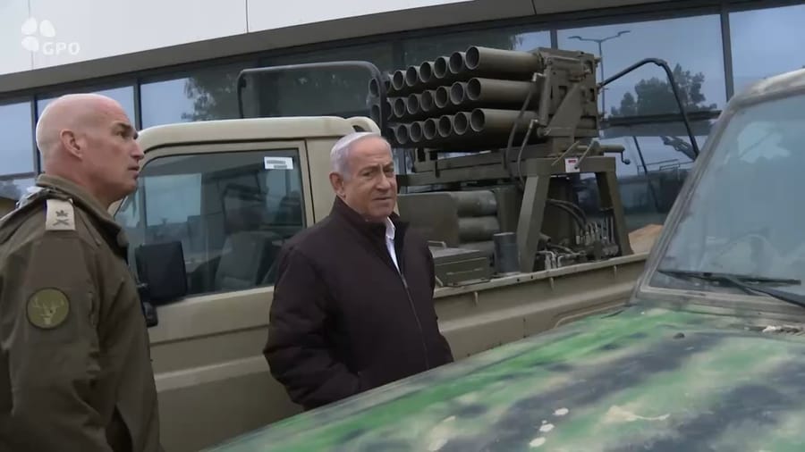 Prime Minister Binyamin Netanyahu examining captured weapons.