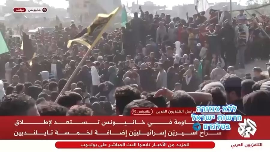 PIJ convoy with huddled masses as hostages are prepared to be released.