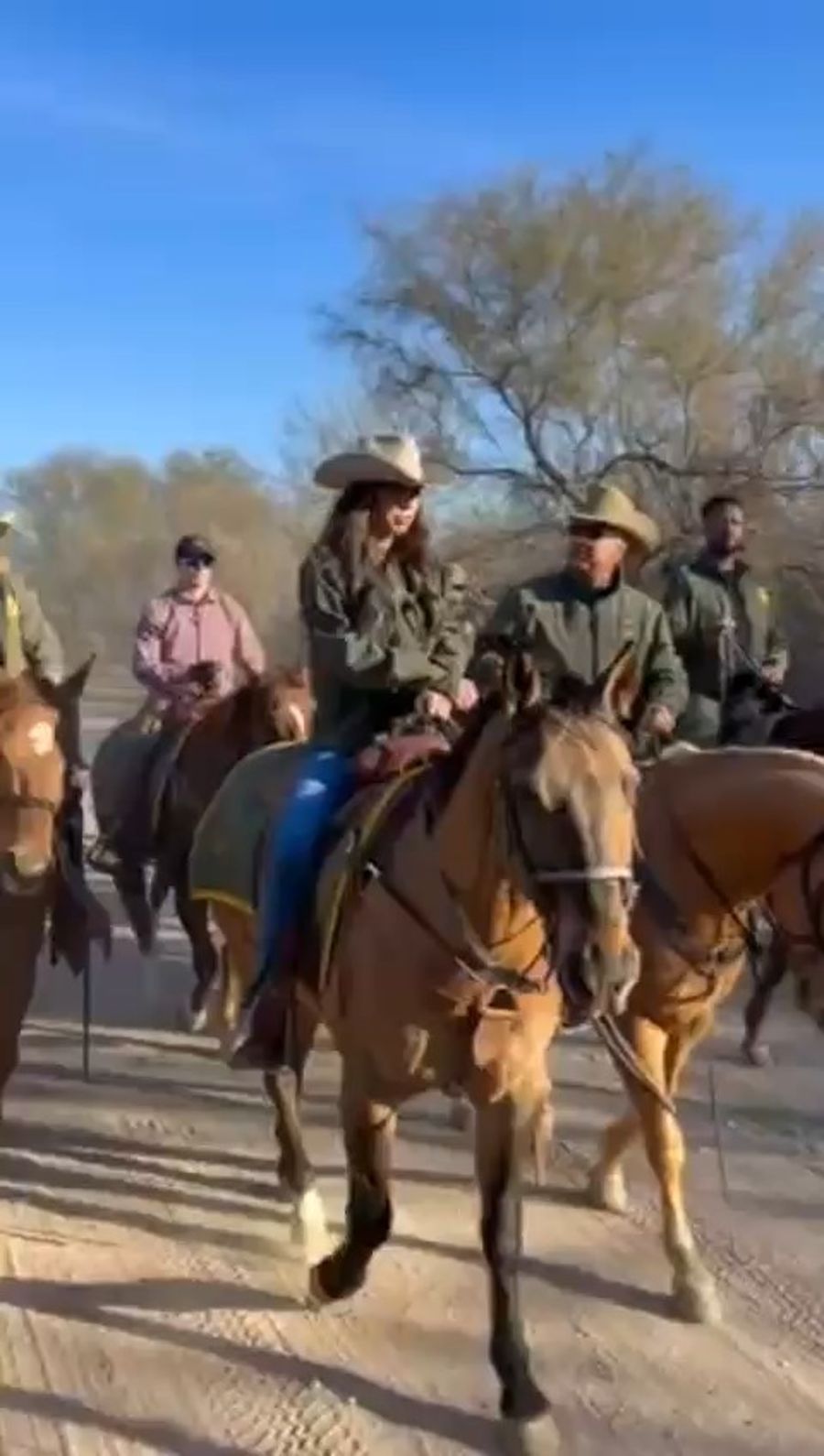 Kirstjen Nielsen rides a horse, while surveying the border