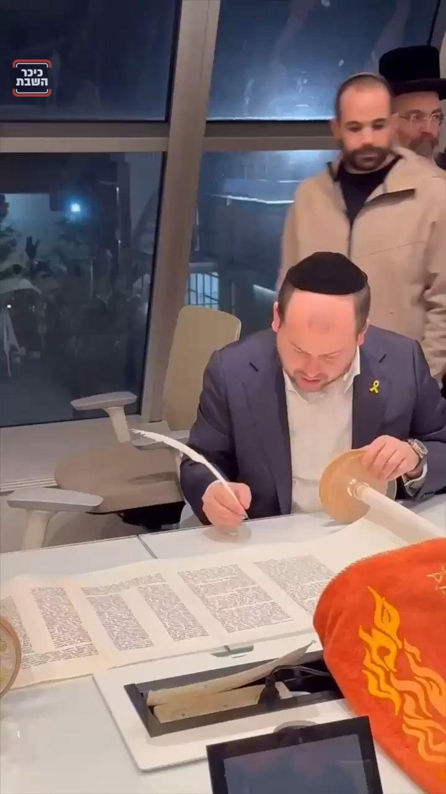 Yarden Bibas writing a Torah scroll