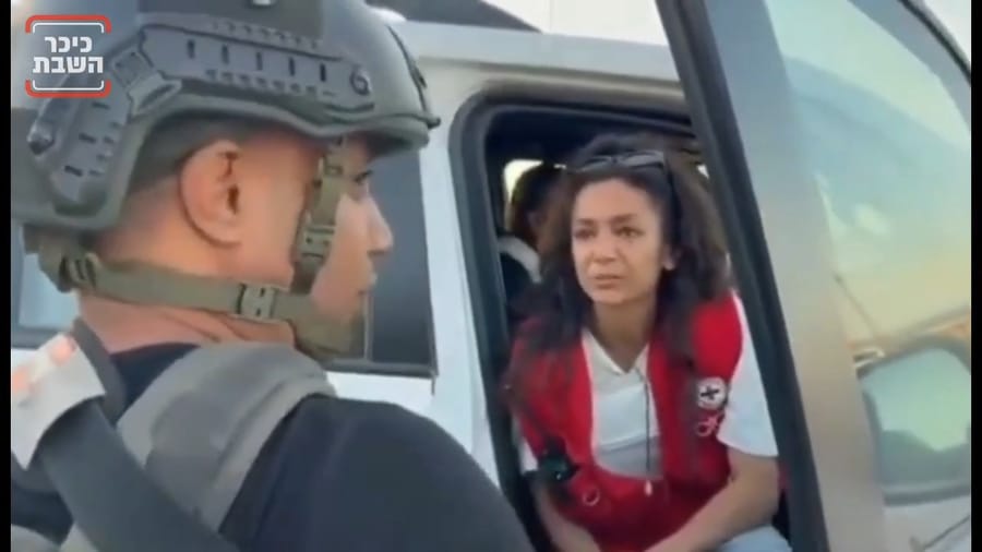 Militia members provide security for Red Cross personnel.
